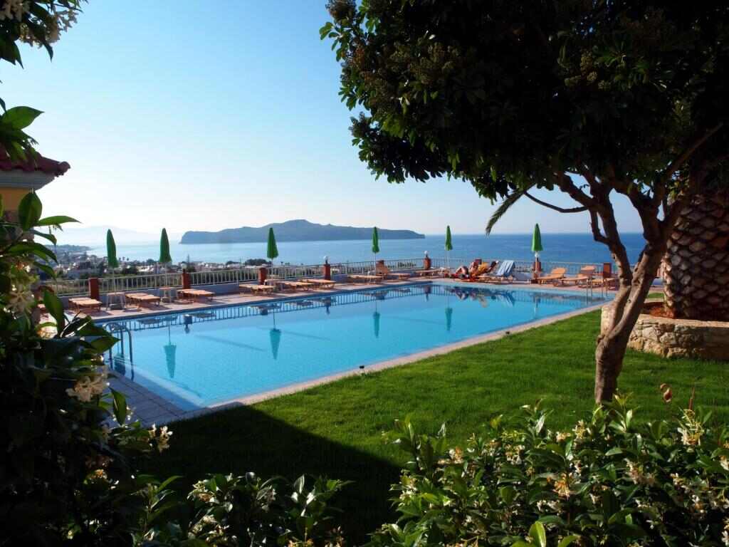 Swimming pool with sea view surrounded by garden